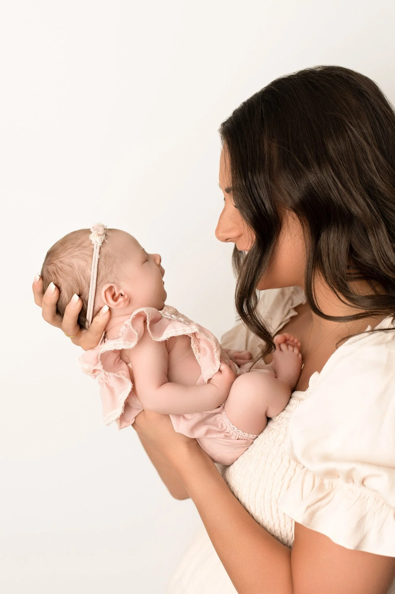 A mother cradling her sleeping newborn